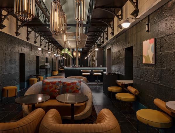 The long bluestone hall of booths at Olivine