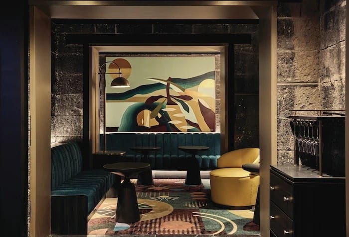 An Olivine booth beneath a framed artwork